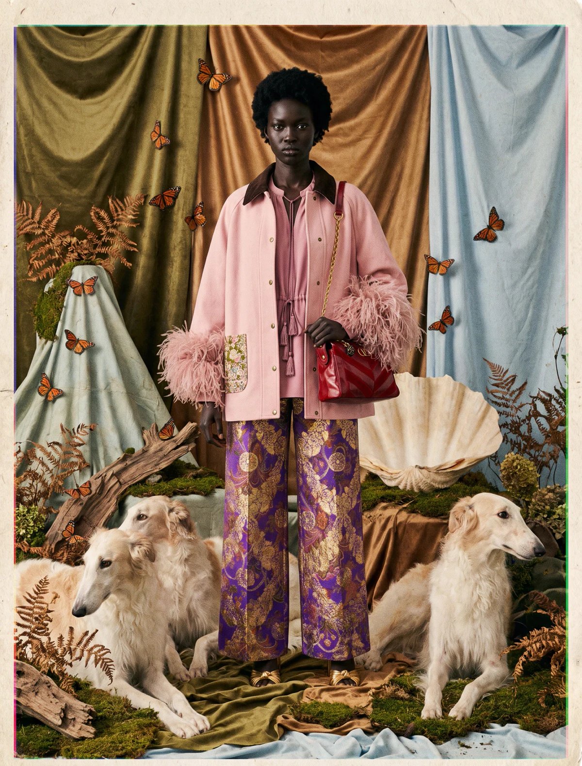 AI-generated on-model image: pink overshirt and printed trousers on a tapestry set with two borzoi dogs
