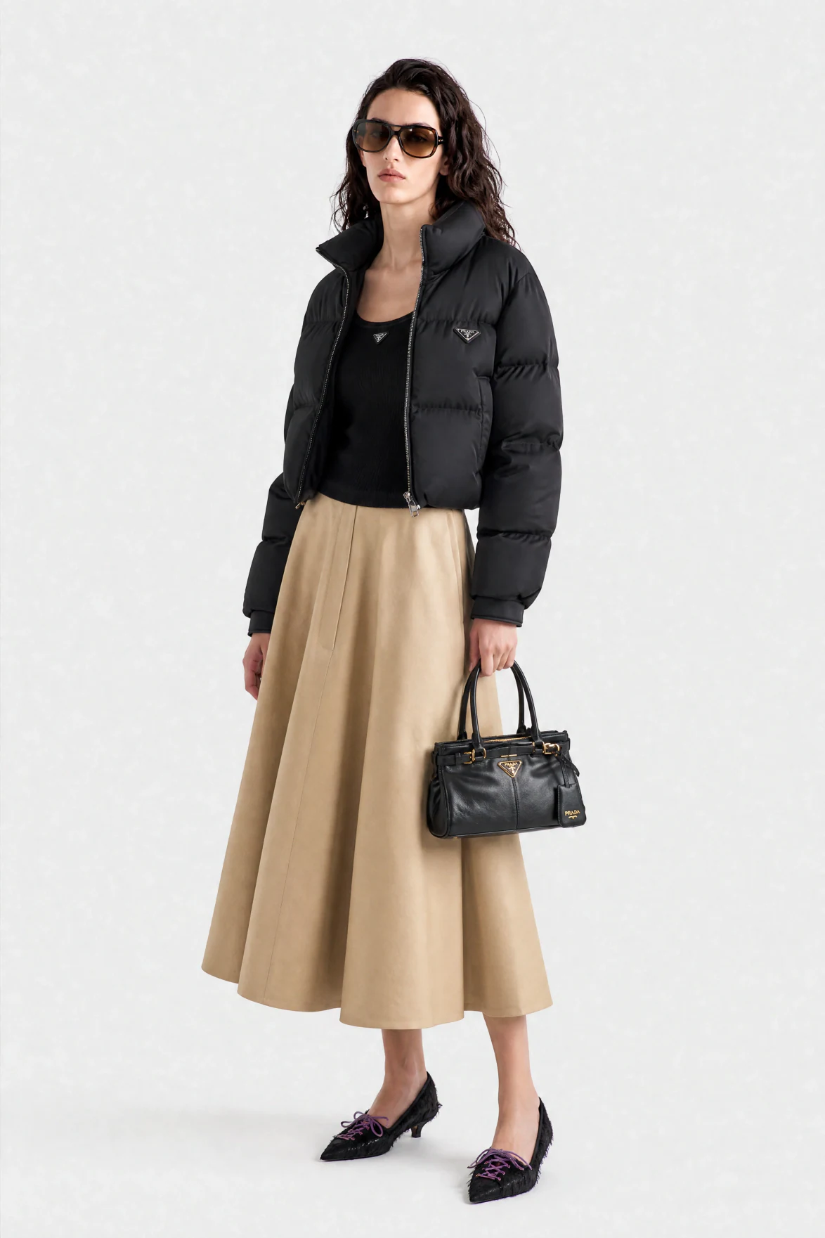 AI fashion model in sunglasses and a black Prada puffer vest, a Genera.Space e-commerce still