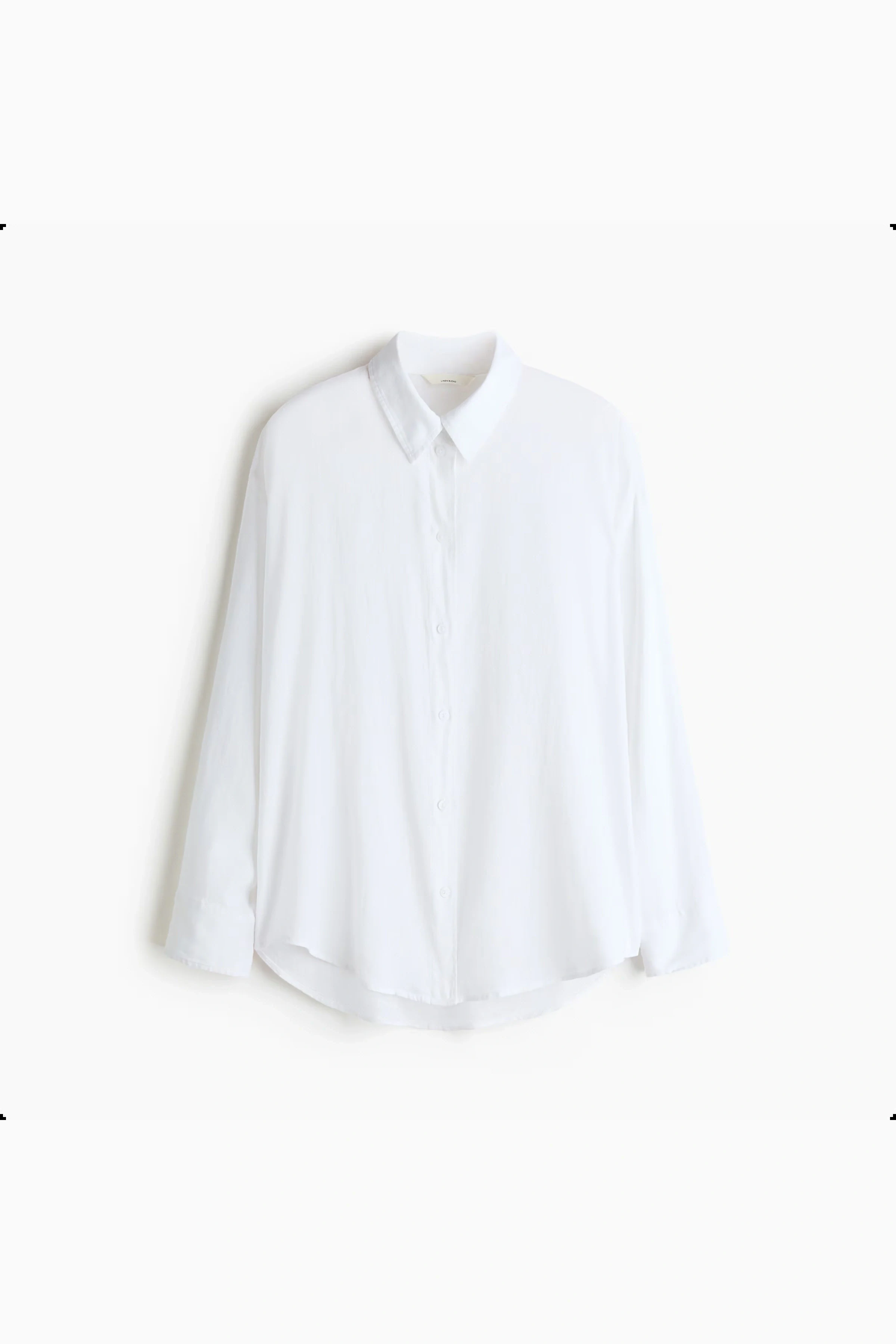 Flat lay packshot of a white button-up shirt
