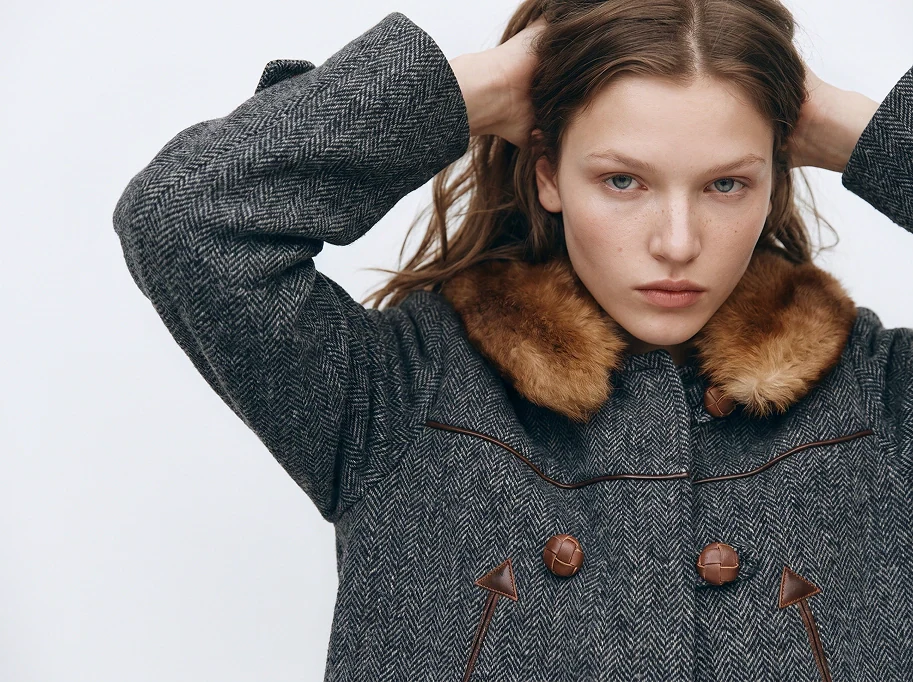 Garment detail the capture standard protects: herringbone weave and fur collar reproduced exactly
