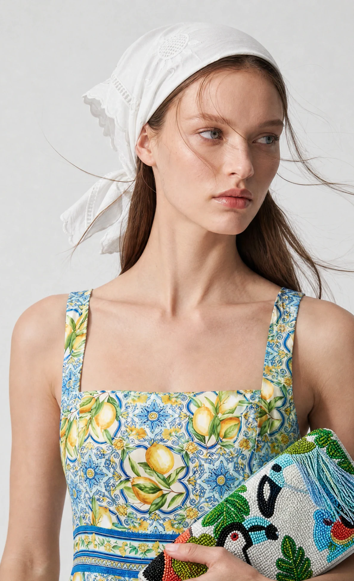 On-model photo generated from a ghost mannequin shot: lemon-print sundress with a white headscarf