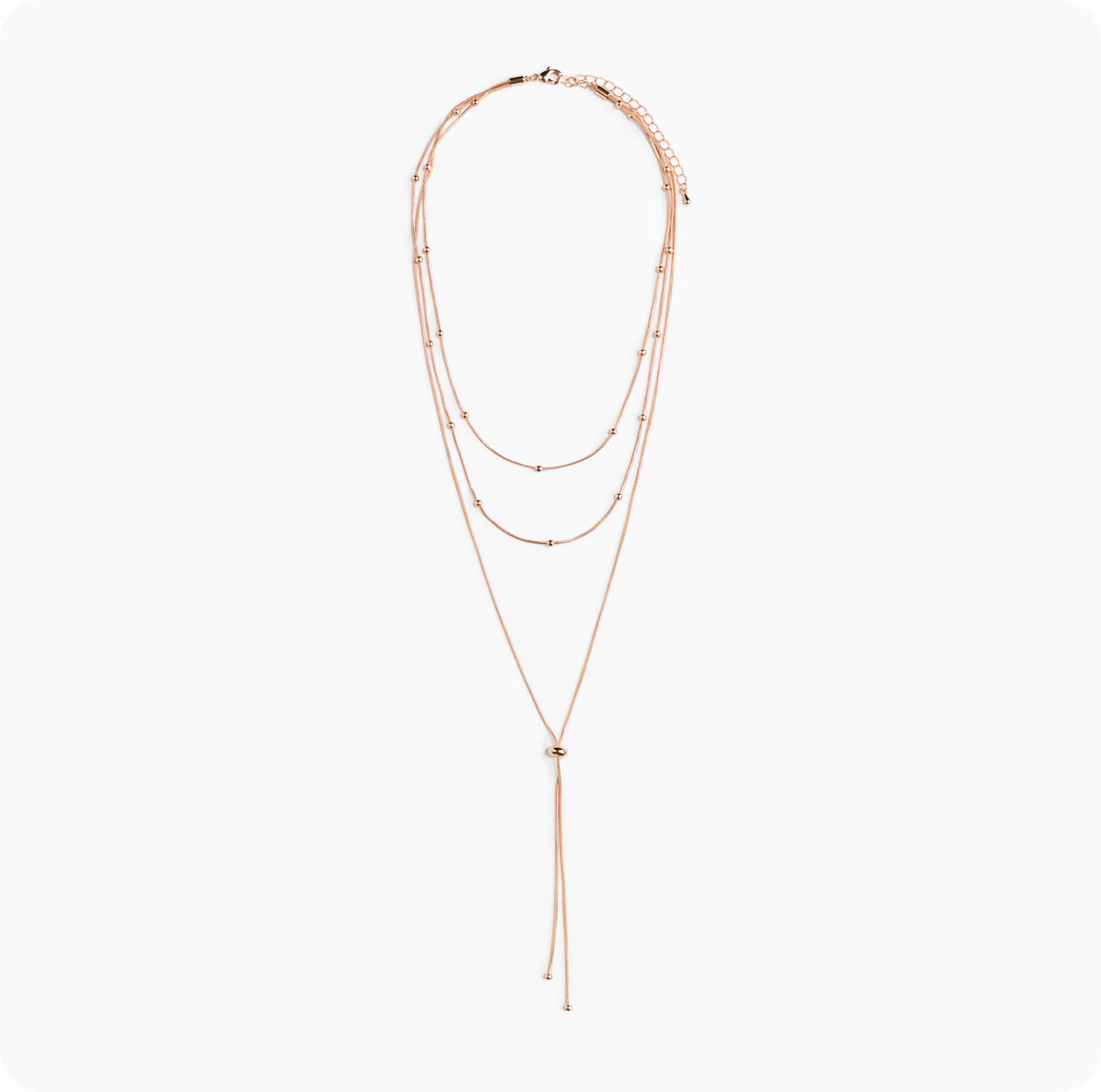 Packshot of a layered necklace on a plain background — what the brand uploaded