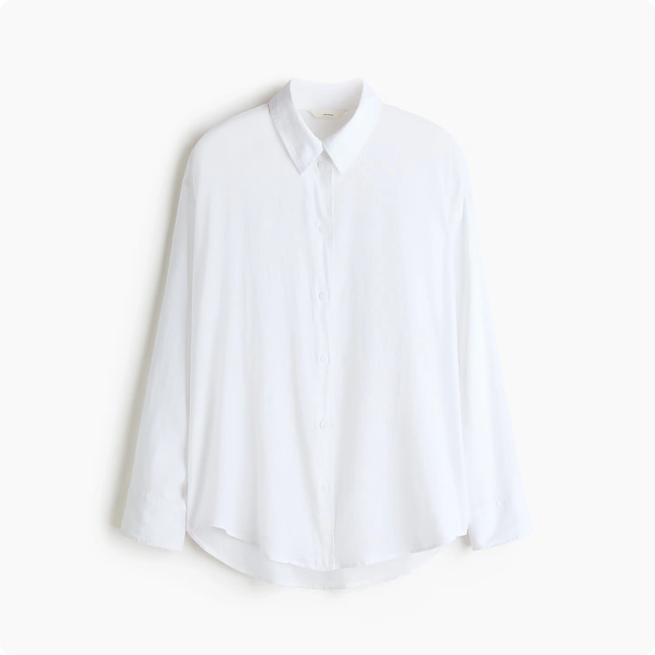 Flat photo of a white shirt on a plain background — what the brand uploaded