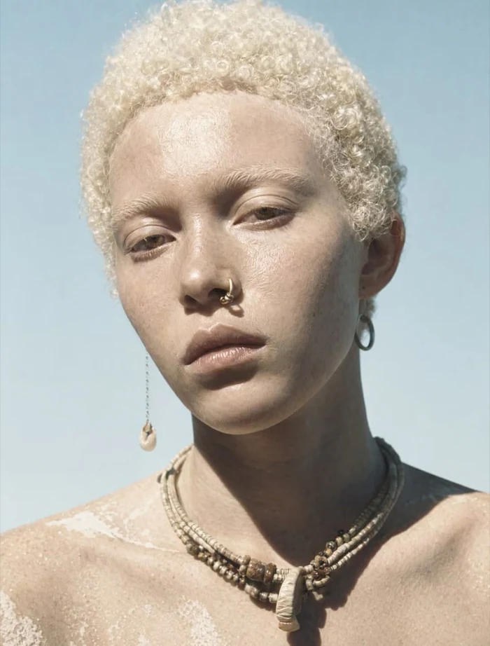 Beauty portrait of an AI fashion model with beaded jewellery against open sky