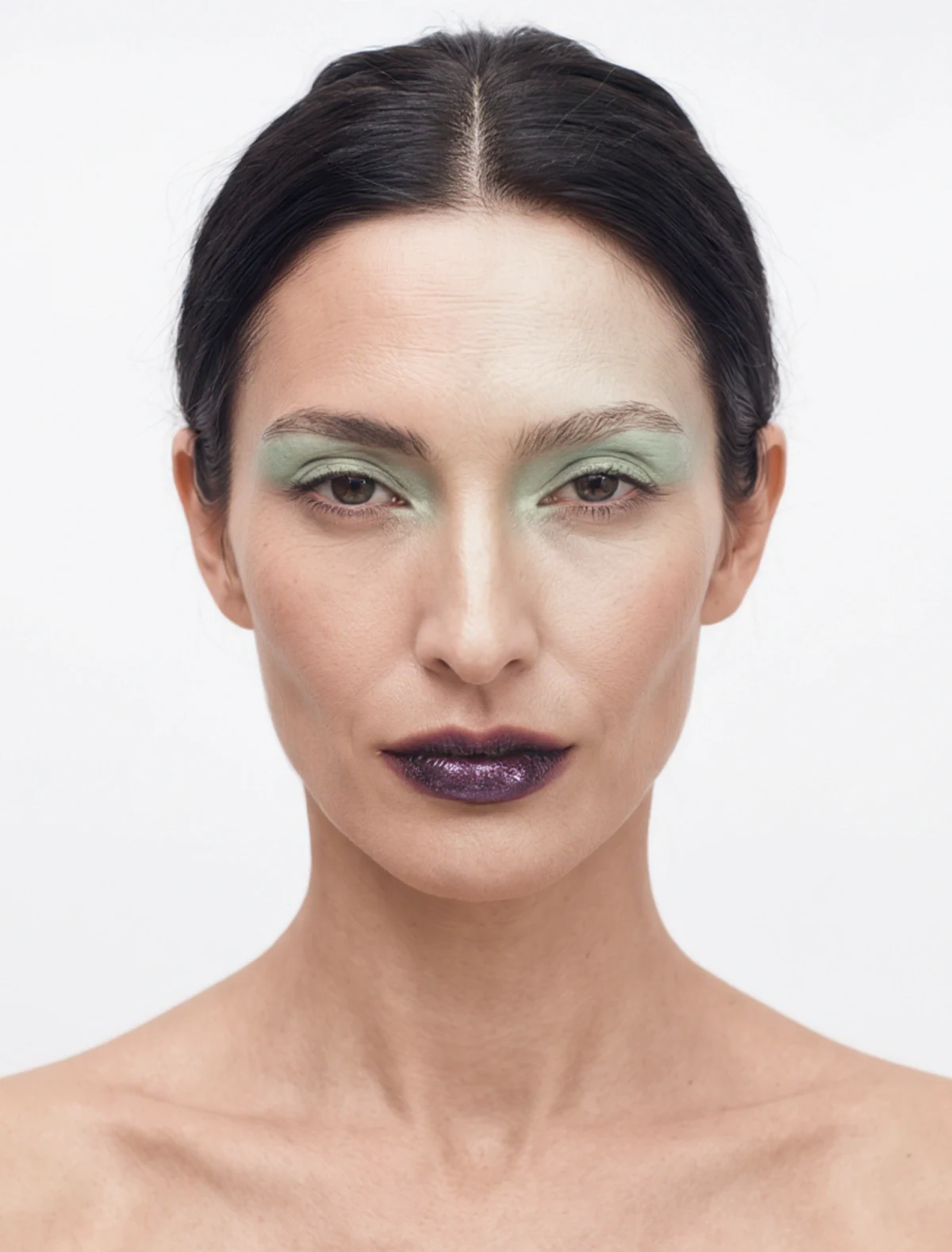 AI-generated beauty portrait: the same AI model identity with green eyeshadow and a dark lip, straight-on close-up