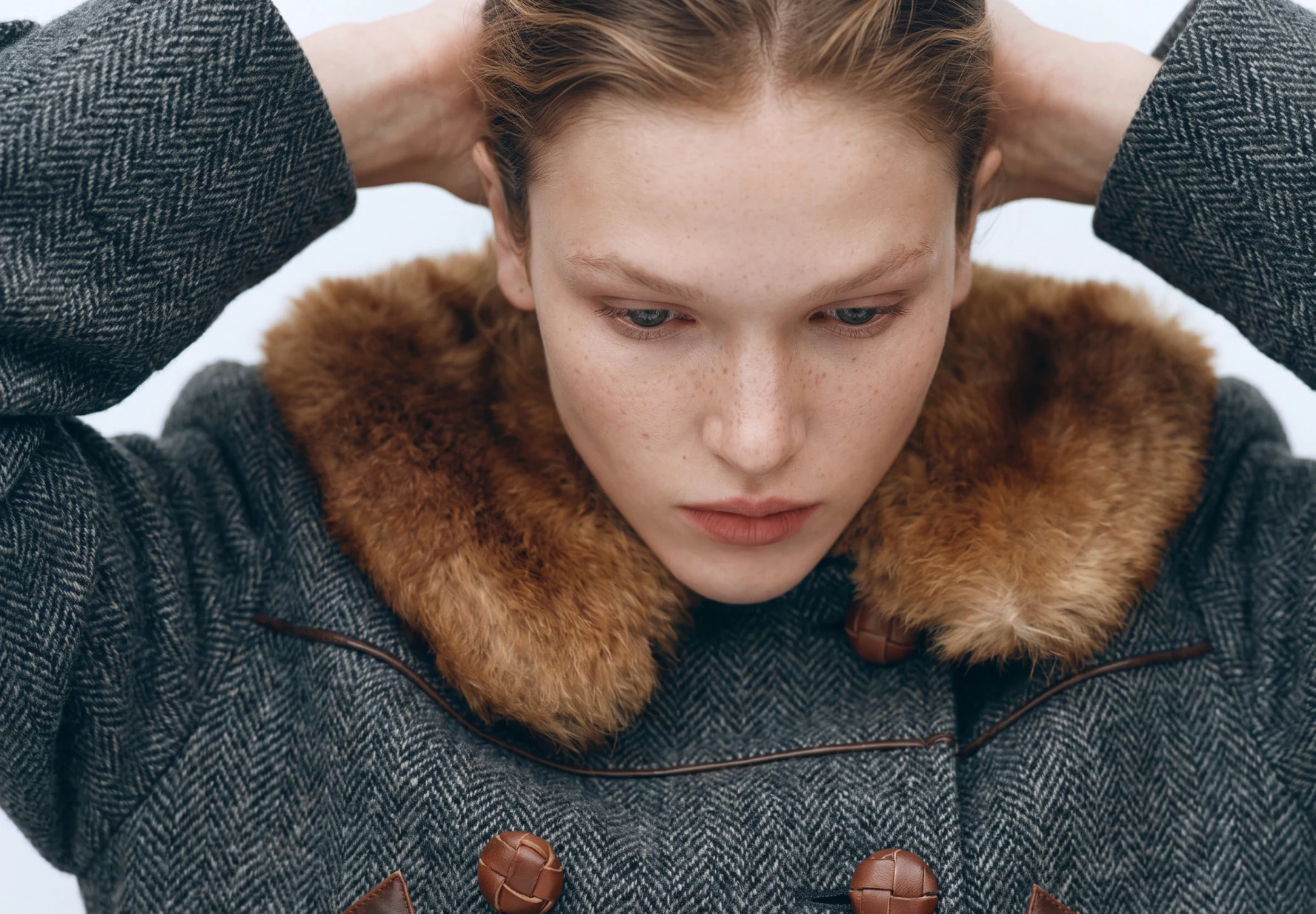 AI-generated on-model image: herringbone coat with a fur collar, close-up wide frame