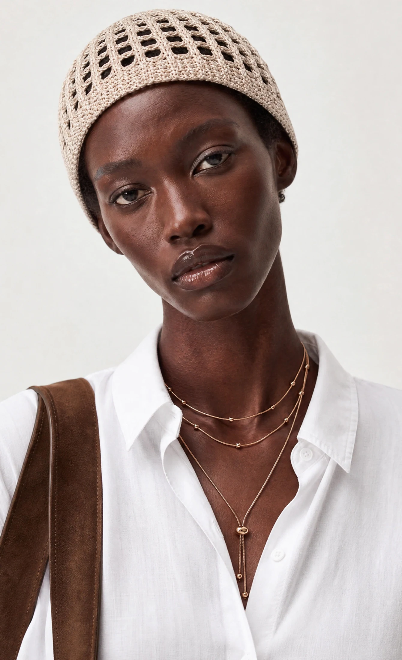 The same necklace worn by an AI model — close-up on-model photo generated by Genera