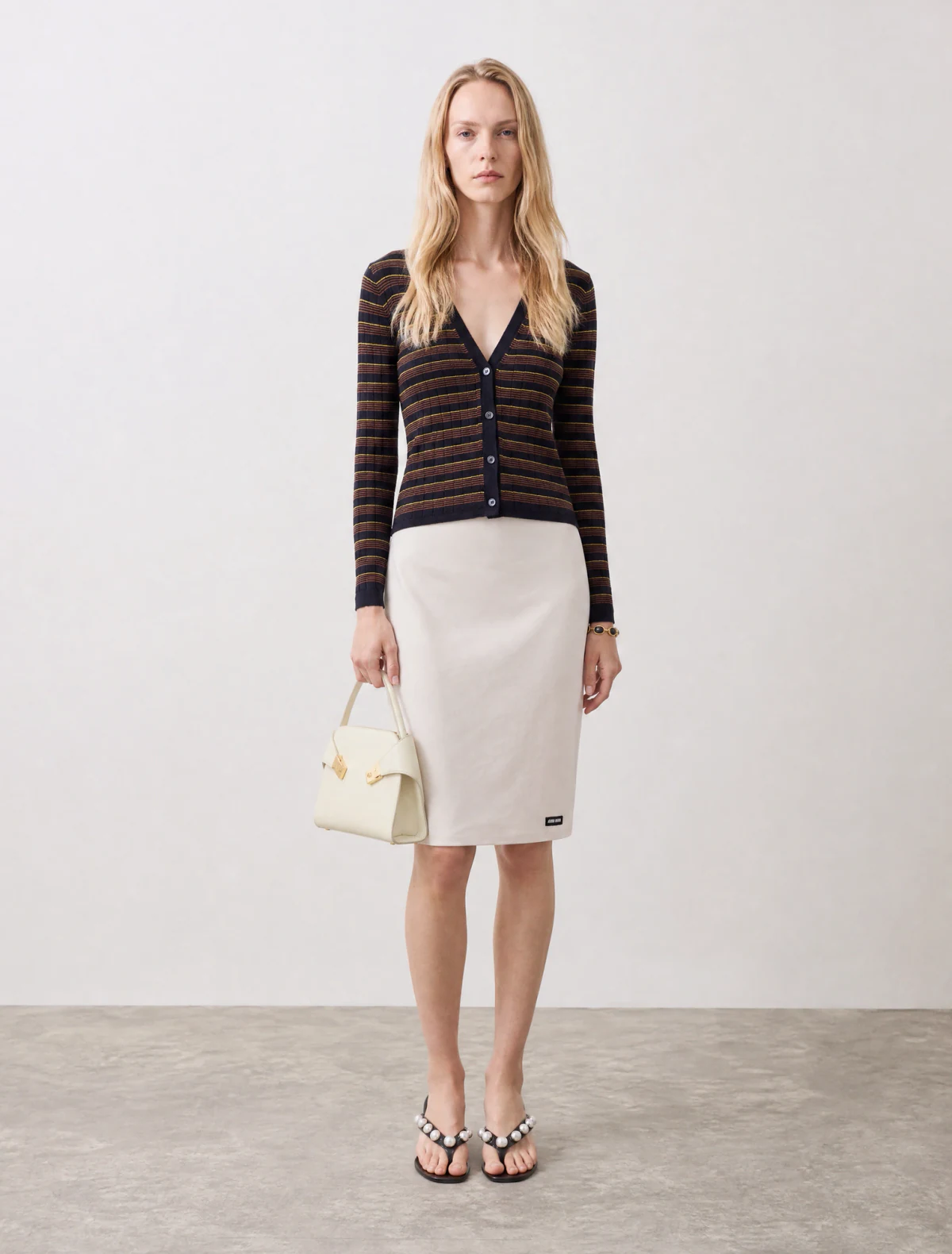 AI-generated on-model image: striped cashmere knit with a pencil skirt