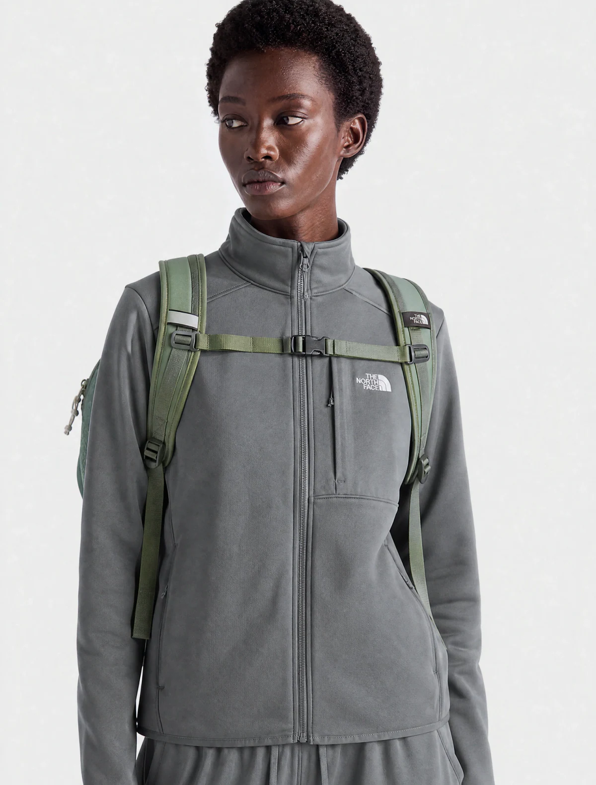 AI-generated on-model image: grey performance fleece jacket with a backpack