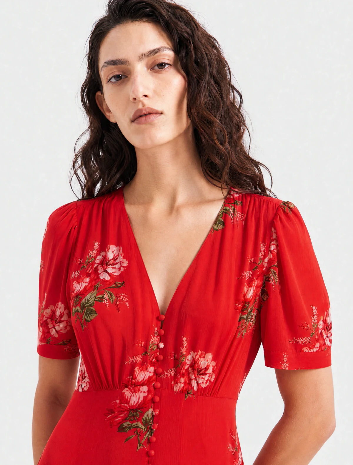 AI-generated on-model image: red rose-print midi dress with a studded black bag