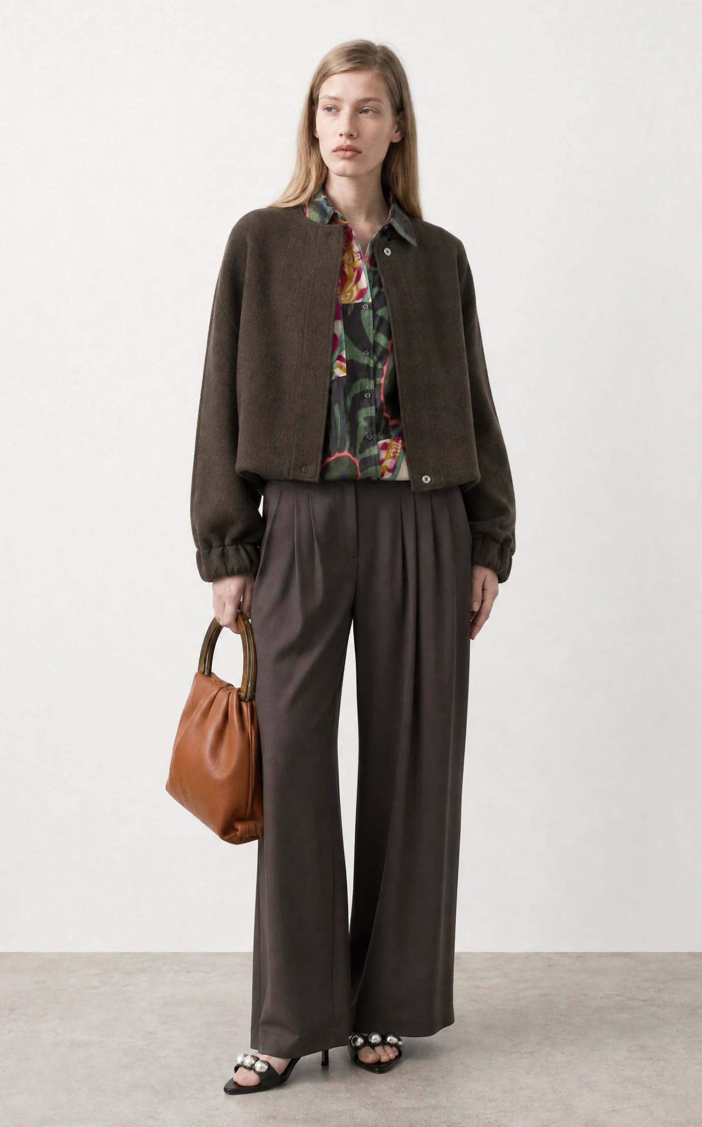 Vestira PDP image — olive blouson jacket with wide pleated trousers, front view